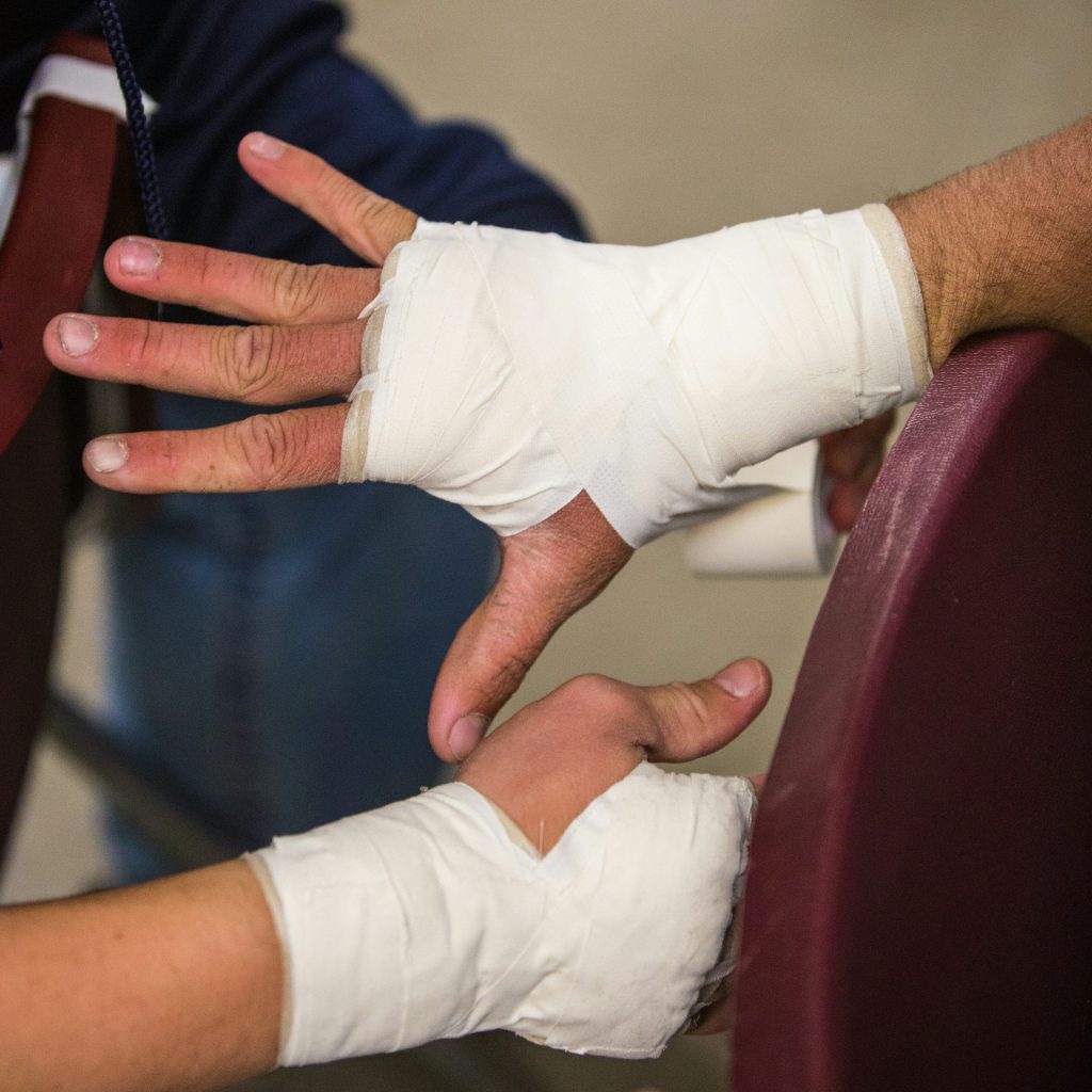 person in white gloves holding persons hand